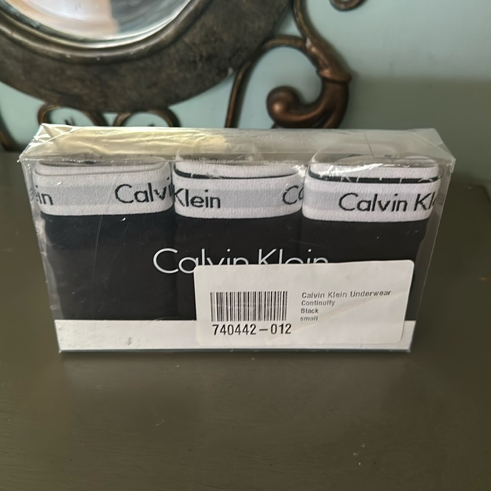 Three Calvin Klein thong size small